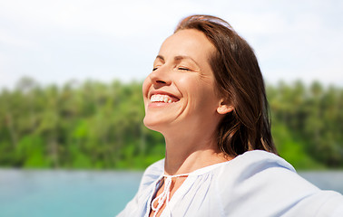 Image showing happy woman over tropical beach background