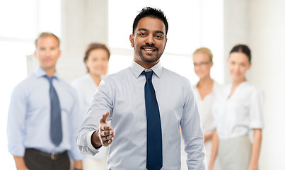 Image showing indian businessman stretching hand for handshake