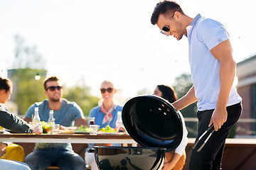 Image showing man grilling on bbq at rooftop party