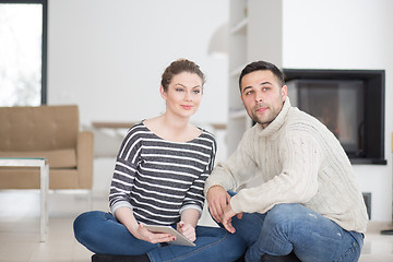 Image showing Young Couple using digital tablet on cold winter day