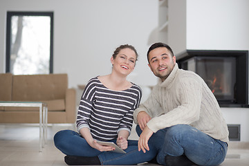 Image showing Young Couple using digital tablet on cold winter day