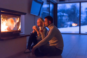 Image showing happy couple in front of fireplace