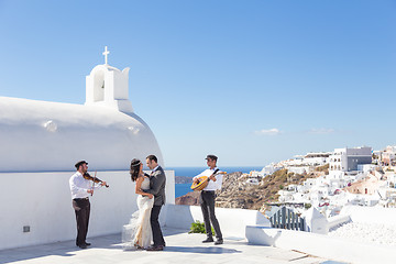 Image showing Bride and groom dansing on wedding ceremony on Santorini island, Greece.