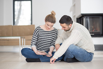 Image showing Young Couple using digital tablet on cold winter day