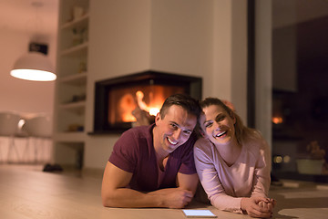 Image showing Young Couple using digital tablet on cold winter night