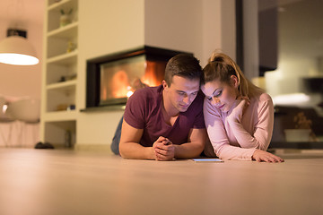 Image showing Young Couple using digital tablet on cold winter night