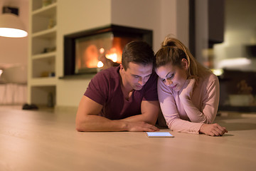 Image showing Young Couple using digital tablet on cold winter night