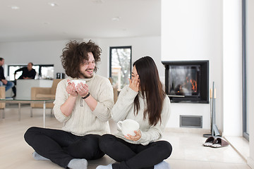 Image showing happy multiethnic couple  in front of fireplace