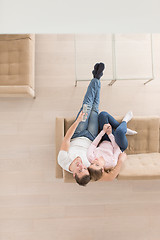 Image showing Young couple on the sofa watching television top view