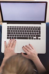 Image showing young woman on sofa at home websurfing