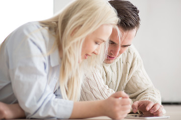 Image showing Young Couple using digital tablet on cold winter day