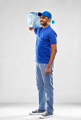 Image showing happy indian delivery man with water barrel