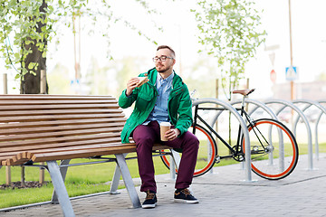 Image showing young man or hipster with coffee eating sandwich