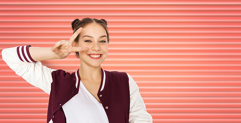 Image showing happy smiling teenage girl showing peace sign