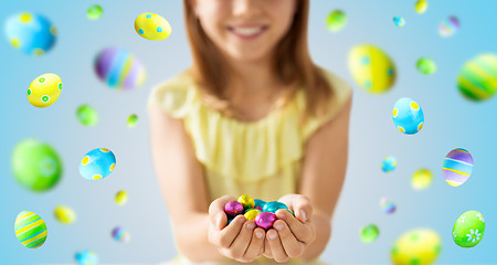 Image showing close up of girl holding chocolate easter eggs