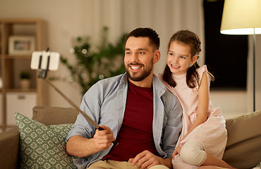 Image showing father and daughter taking selfie at home