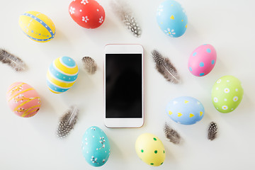 Image showing smartphone with easter eggs and quail feathers