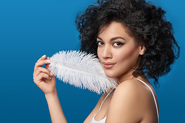 Image showing Beautiful mixed race woman holding white ostrich feather