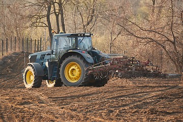 Image showing Tractors working on a field