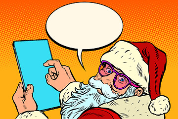 Image showing Santa Claus with a tablet. merry Christmas and happy new year