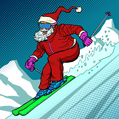 Image showing Skier evening rides down the mountain. Santa Claus character merry Christmas and happy new year