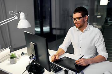 Image showing designer with computer and pen tablet at office