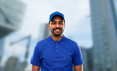 Image showing happy indian delivery man in blue uniform