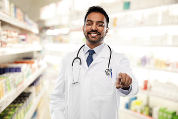 Image showing smiling indian male doctor pointing finger to you