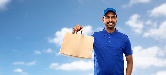 Image showing happy indian delivery man with food in paper bag
