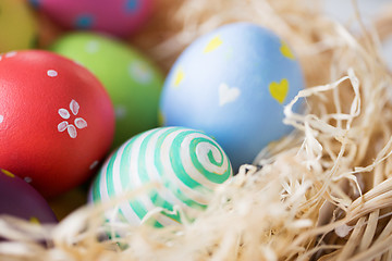 Image showing close up of colored easter eggs in straw