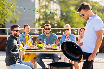 Image showing man grilling on bbq at rooftop party