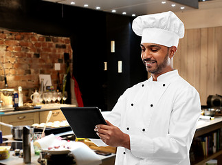 Image showing happy indian chef with tablet computer at kitchen