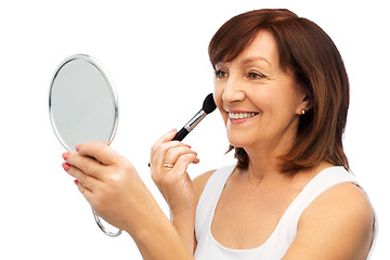 Image showing senior woman with mirror and make up blush brush