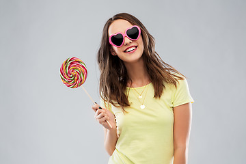 Image showing teenage girl in sunglasses with lollipop