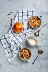 Image showing Granola in bowls and a jug of milk for breakfast.