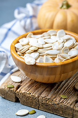 Image showing Unpeeled pumpkin seeds in a wooden bowl.