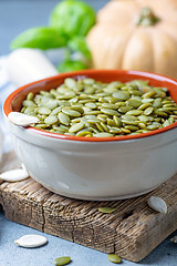 Image showing Raw pumpkin seeds in a ceramic bowl.