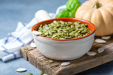 Image showing Organic pumpkin seeds in a ceramic bowl.