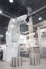 Image showing Automatic robot arm working in industrial environment