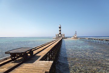 Image showing Long wooden piel leading into the sea