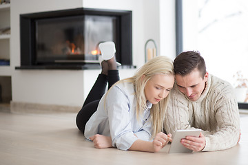 Image showing Young Couple using digital tablet on cold winter day