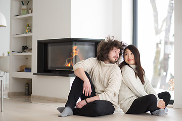 Image showing happy multiethnic couple  in front of fireplace