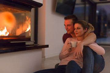 Image showing happy couple in front of fireplace