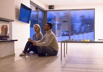 Image showing happy couple in front of fireplace