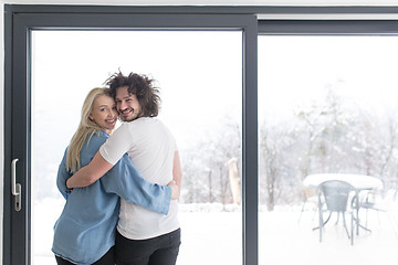 Image showing young couple enjoying morning coffee by the window