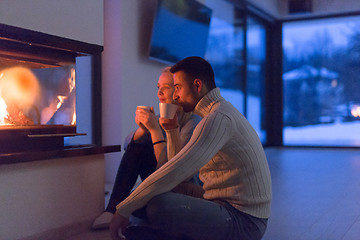 Image showing happy couple in front of fireplace