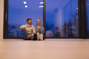 Image showing happy couple in front of fireplace