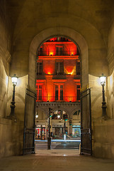 Image showing Paris, France - August 04, 2006: The arch to the Vivienne Gallery is an illuminated street lamp a tourist attraction of Paris in France.