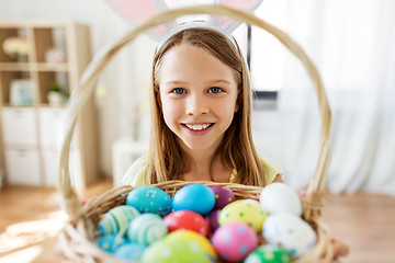 Image showing happy girl with colored easter eggs at home