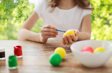 Image showing close up of girl coloring easter eggs